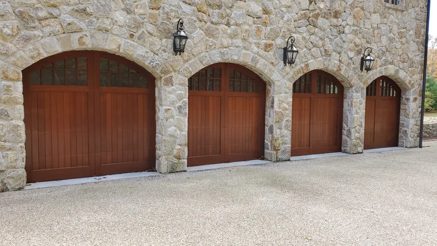 The same garage doors after sanding and a fresh rich wood stain finish