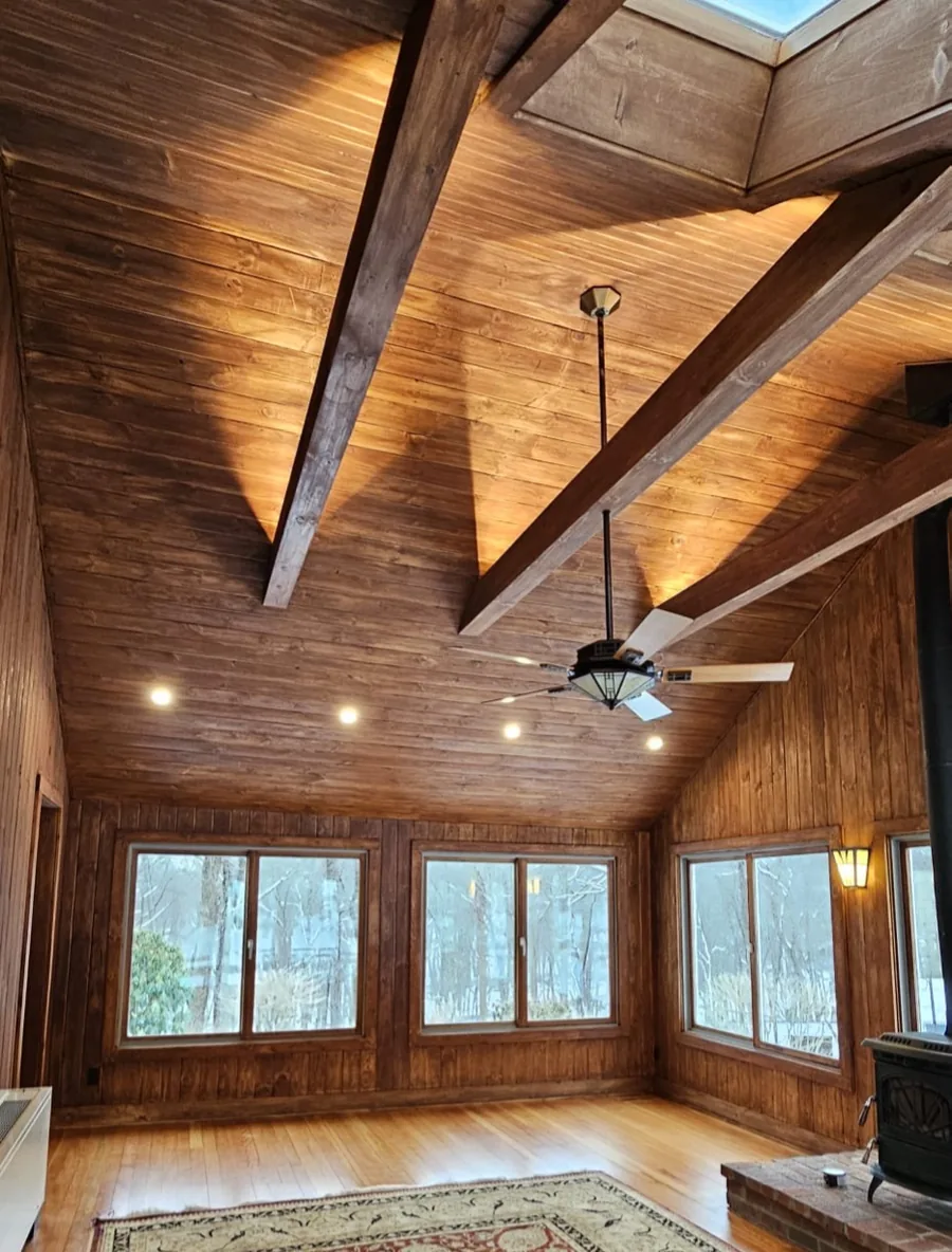 The finished vaulted wood ceiling and beams with a warm even stain throughout the room